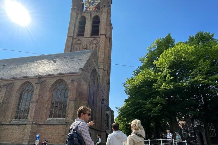 Guide and group in front of Old Church. Delft