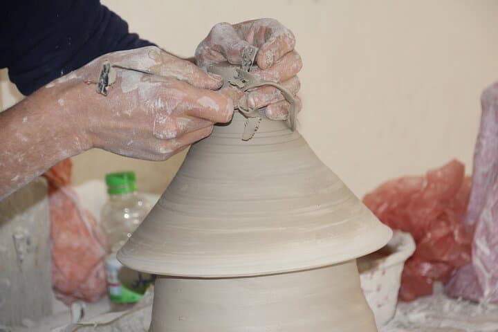Shaving the top of the tagine using a metal tool